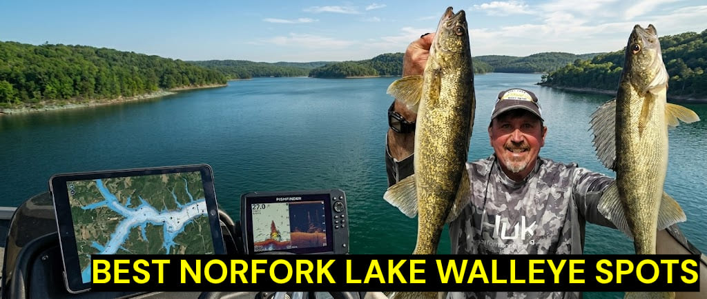 A panoramic wide-angle shot from the helm of a fishing boat on Norfork Lake, Arkansas. On the right, a smiling fisherman in a Huk camouflage shirt and cap holds up two large, golden walleyes. The background features a vast lake surrounded by lush, green forested hills under a bright sky. On the left, the boat's console displays a tablet with a satellite map of the lake and a fishfinder screen showing underwater sonar data. The deep turquoise water and the boat's steering wheel are visible in the foreground.