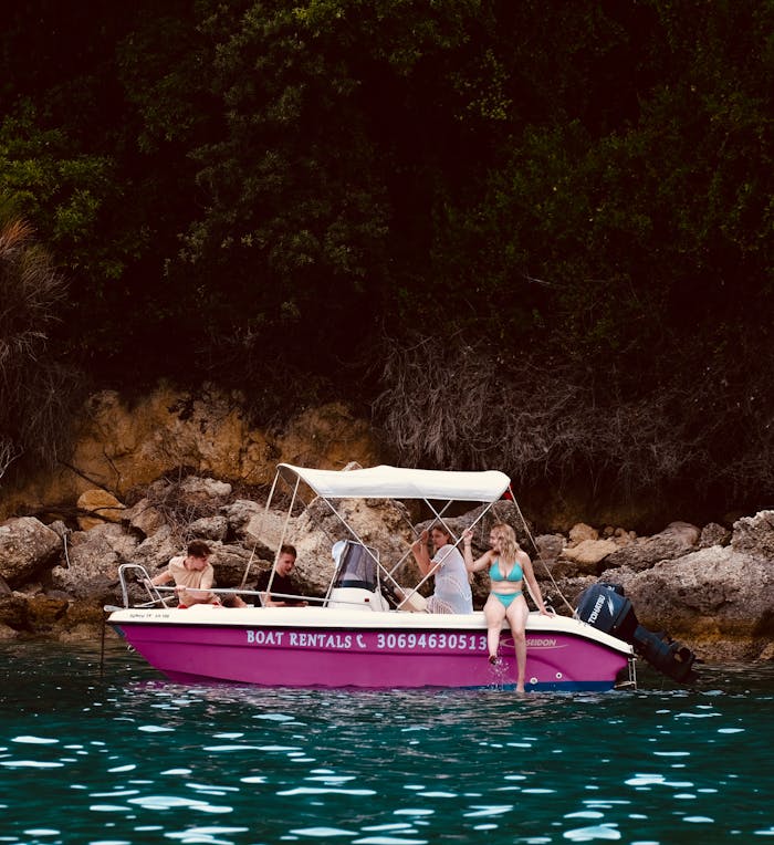A group of friends enjoying a boat ride along the lush coast of Perdika, Greece.