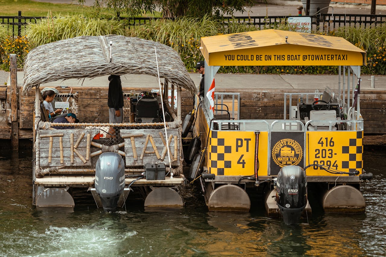 Two water taxi boats moored at a canal dock, ideal for tourism and city tours.
